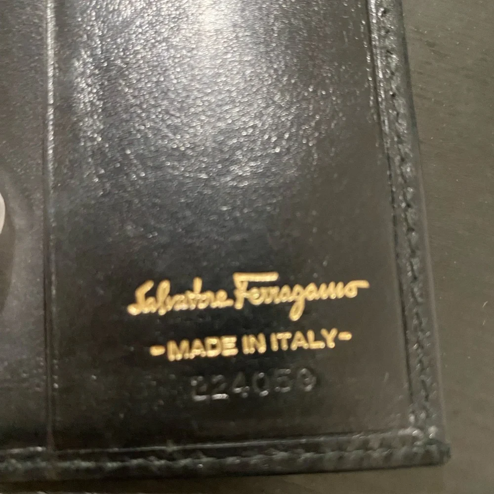 Authentic Ferragamo black leather trifold wallet gold with callouts